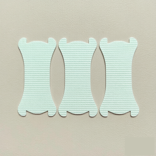 Nasal strip material selection samples Three identical mint-green nasal strips arranged side by side as material selection samples