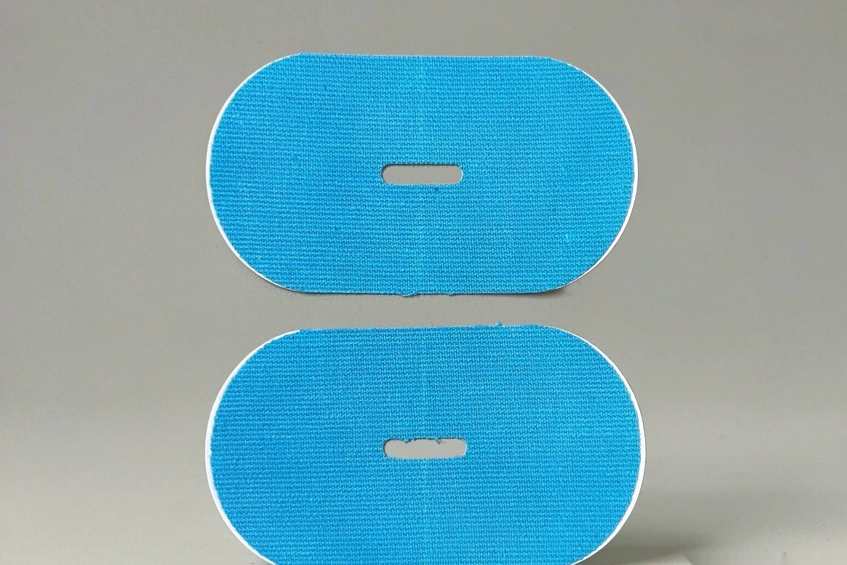 Blue oval mouth tape patches with central breathing holes on light gray background