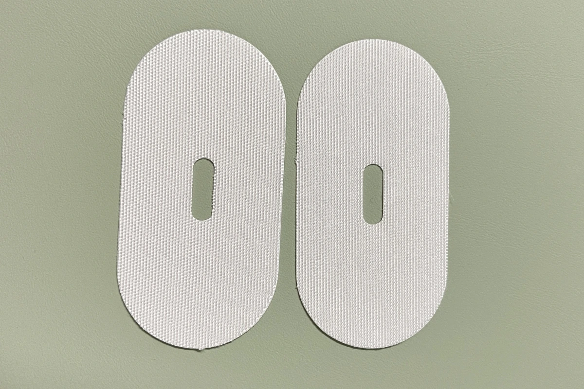 Cream oval mouth tape patches with a central breathing hole