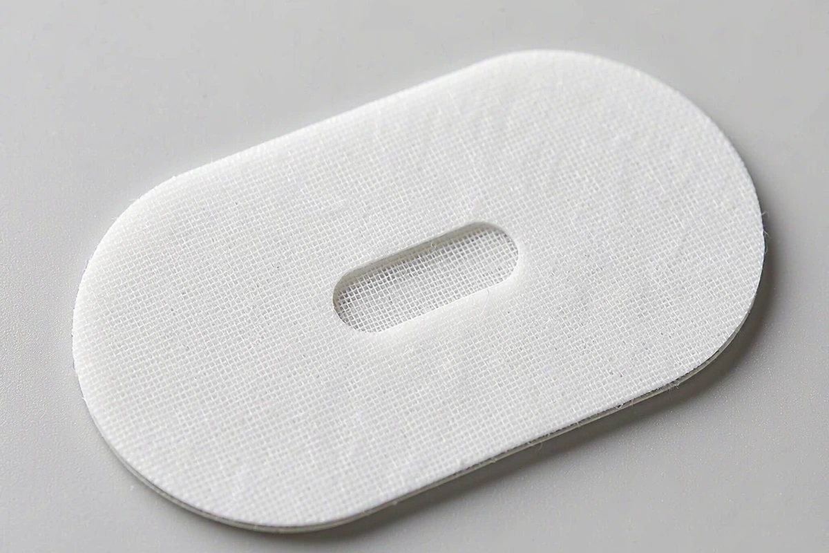 Macro close-up of a vented mouth tape showing the center opening, patch edge and adhesive contact area